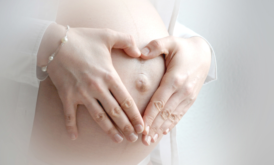 ein Herz mit den Händen - schwangerschaftsfoto
