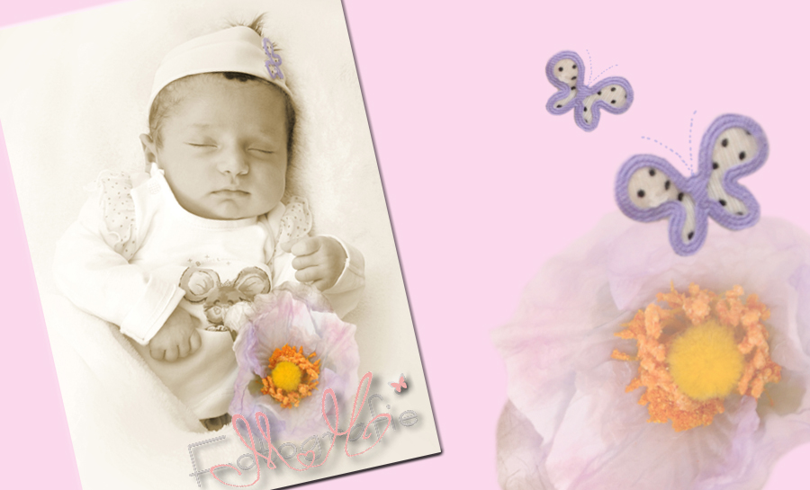neugeborenes kleines Mädchen mit einer Blume und Stirnband