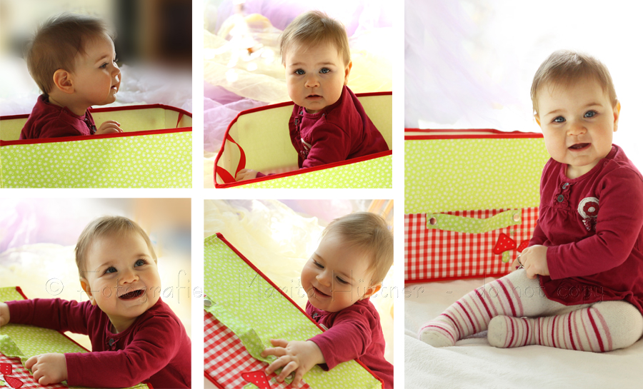 Baby - Mädchen - spielt mit einer Kiste
